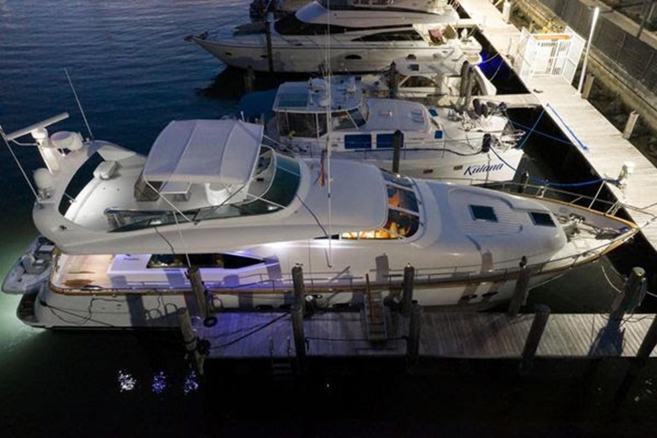 a boat docked at a pier aboard 1997 MAIORA FIPA 70' FLYBRIDGE Yacht for Sale