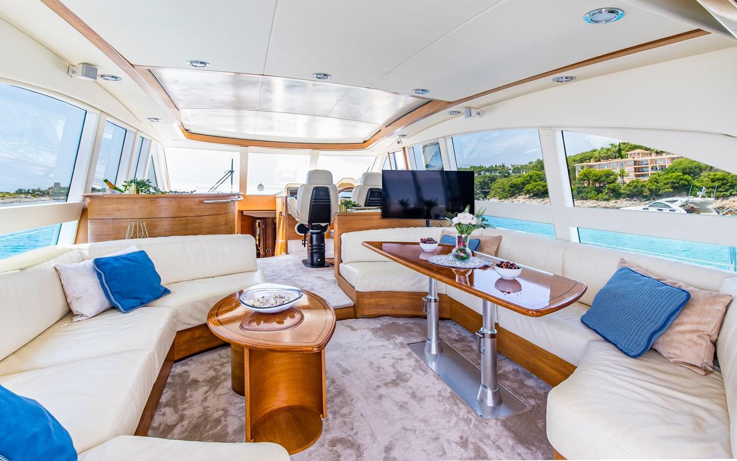 a living room with a table and couches aboard PARODIA Yacht for Sale