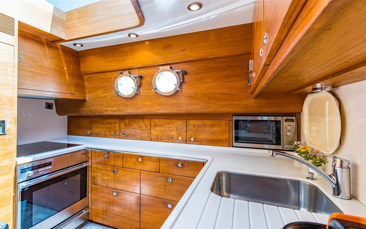 a kitchen with wooden cabinets aboard PARODIA Yacht for Sale