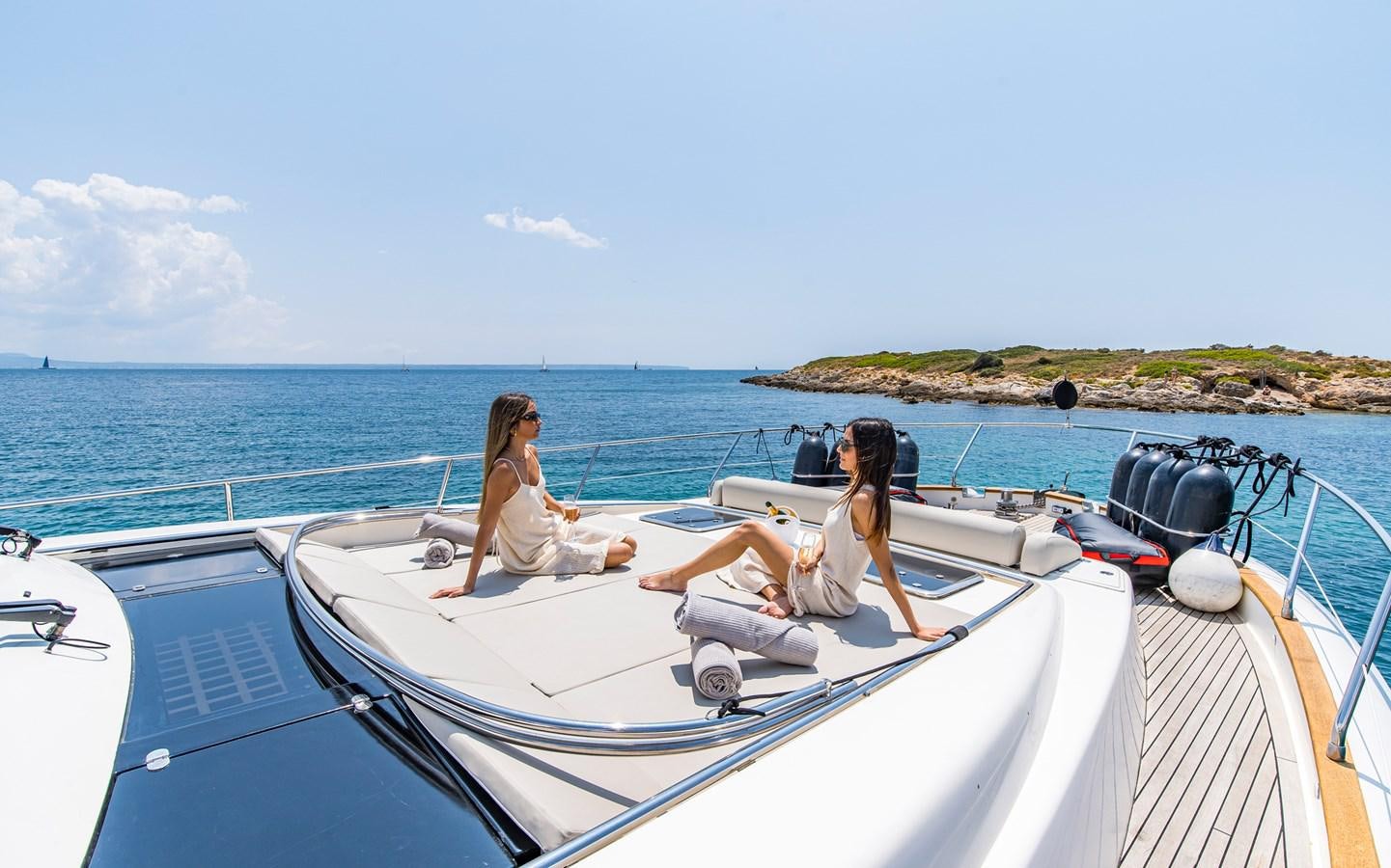 a couple of women sitting on a boat aboard PARODIA Yacht for Sale