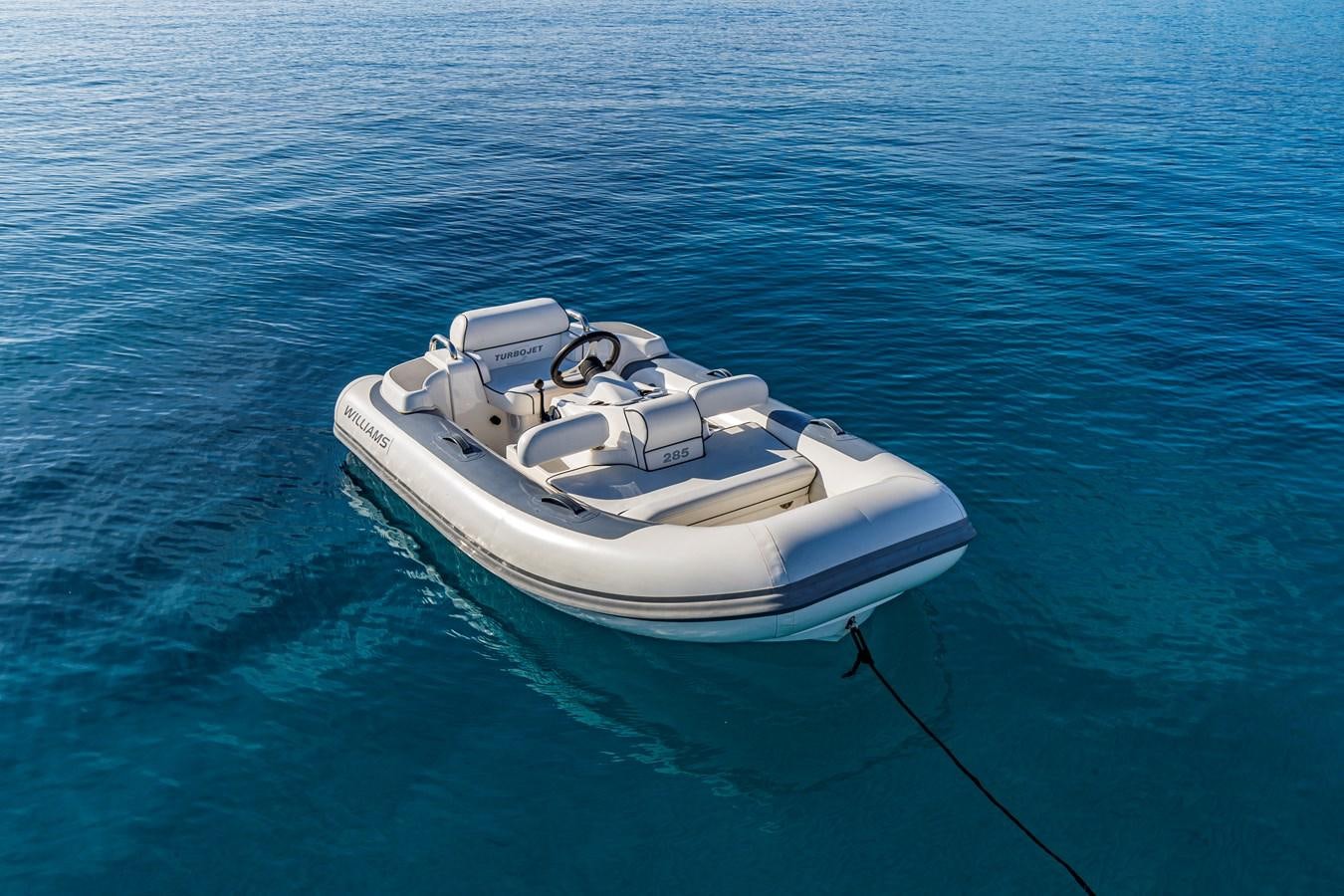 a white boat on water aboard BLUE M Yacht for Sale