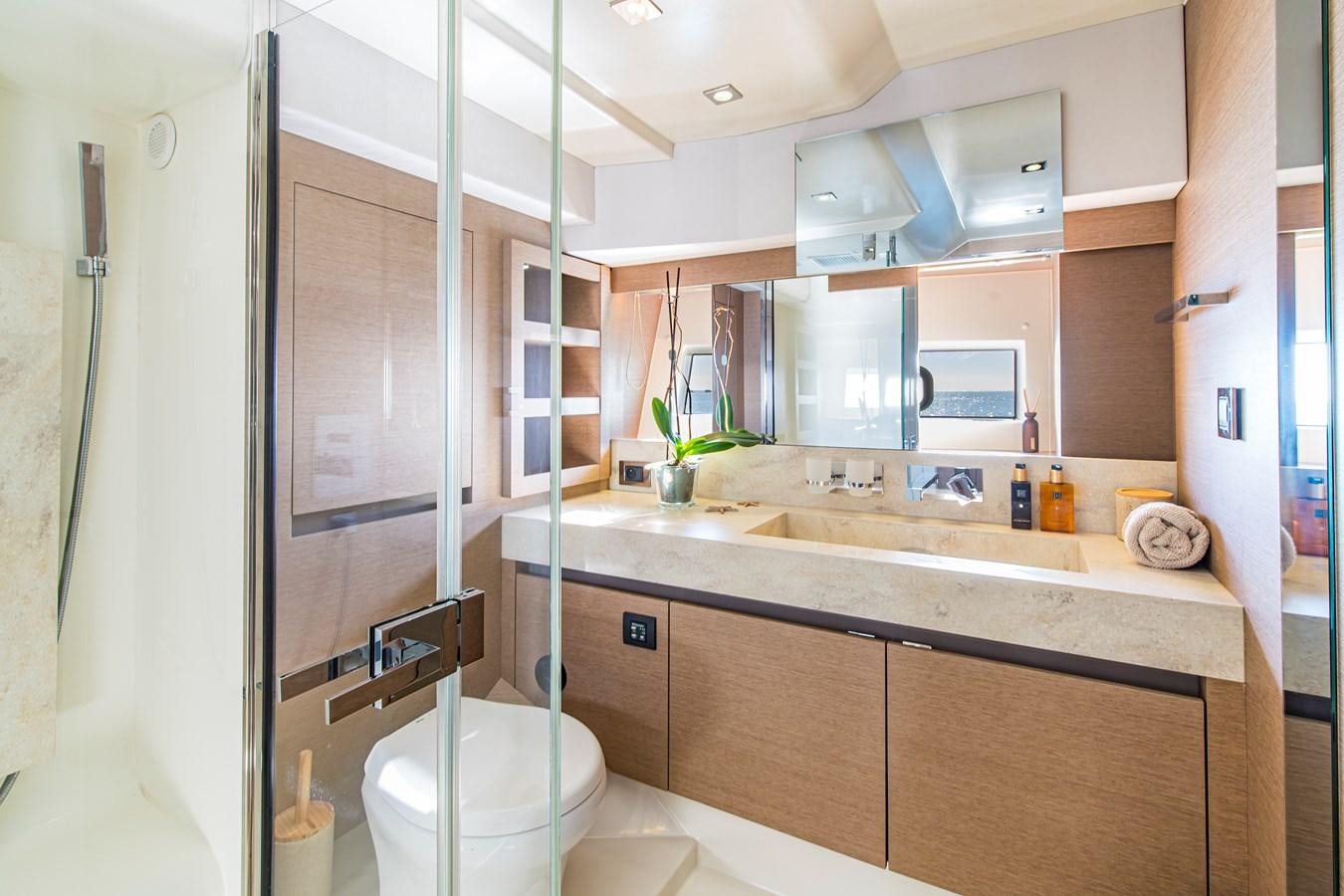 a bathroom with a glass shower door aboard BLUE M Yacht for Sale