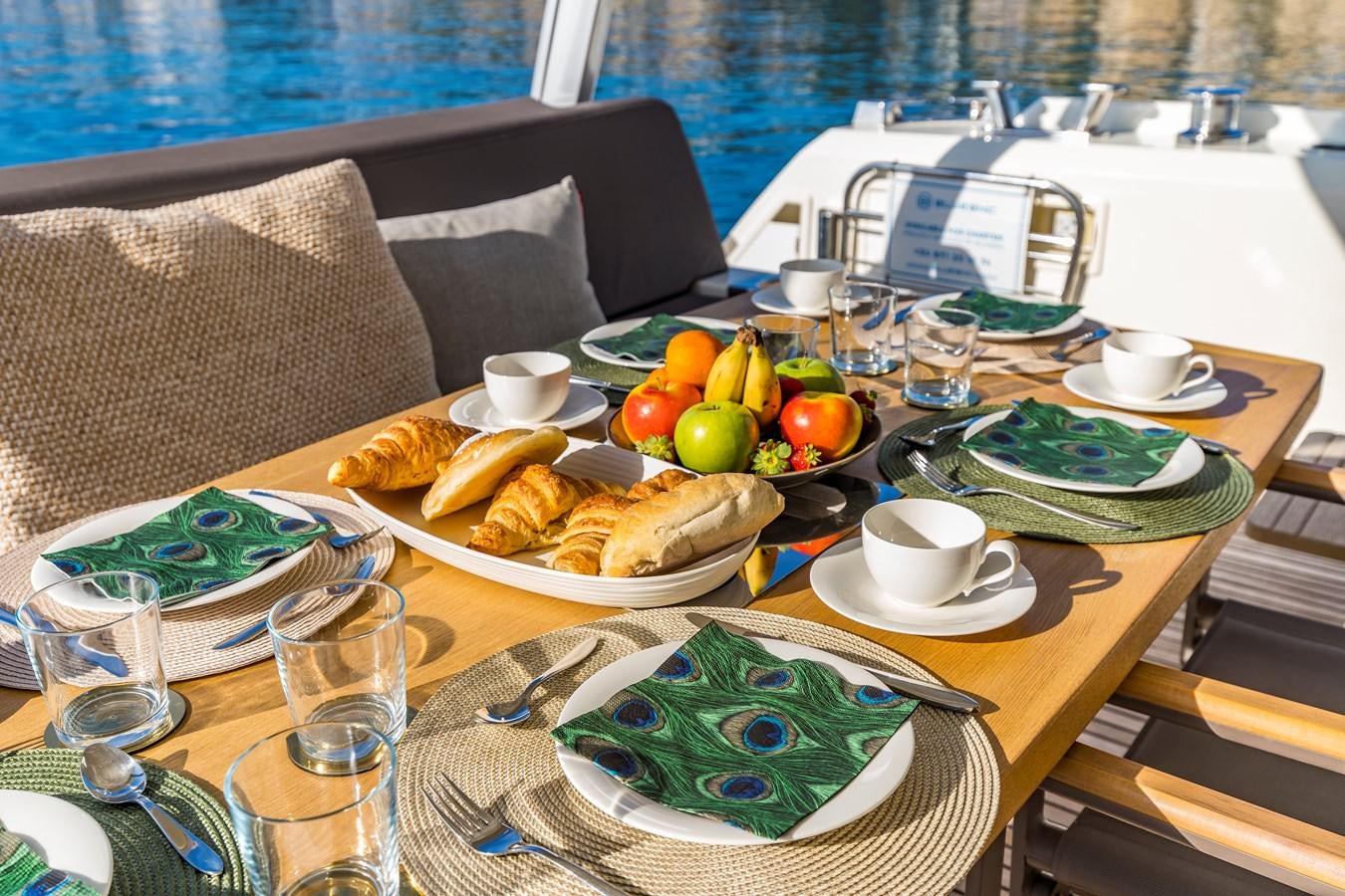a table with food and drinks on it aboard BLUE M Yacht for Sale