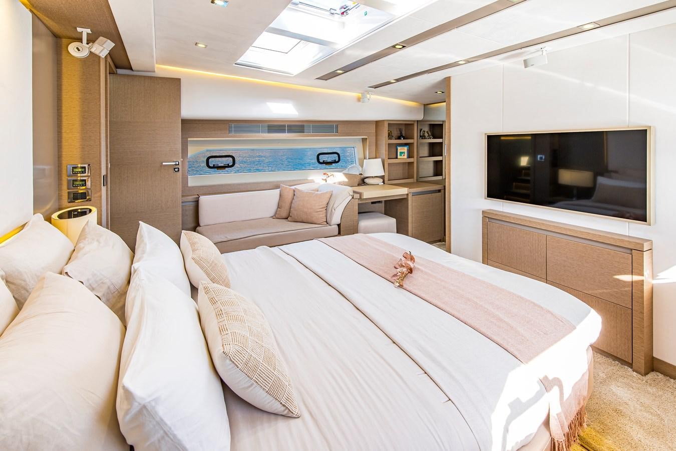 a room with a bed and a tv aboard BLUE M Yacht for Sale