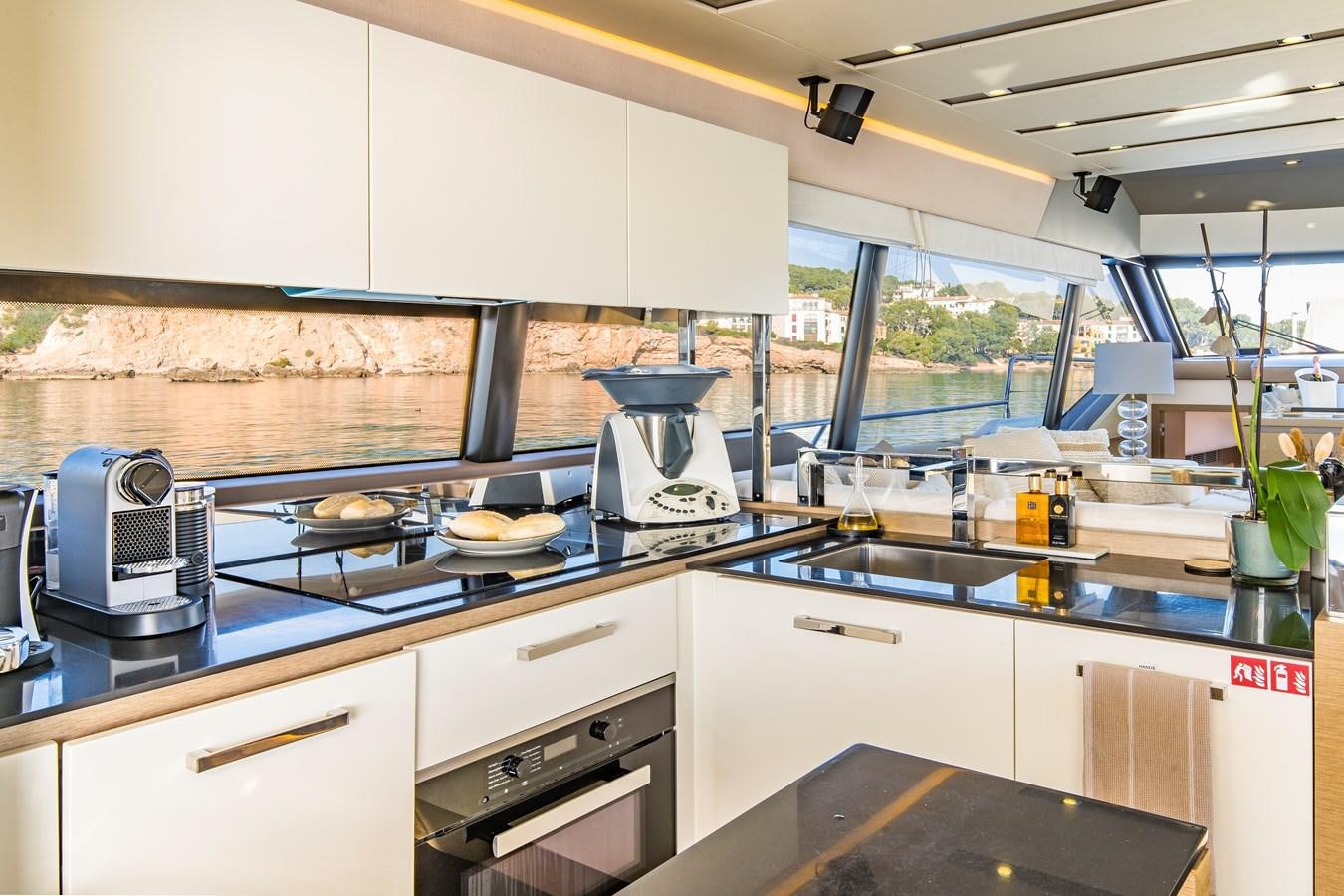 a kitchen with a large window aboard BLUE M Yacht for Sale