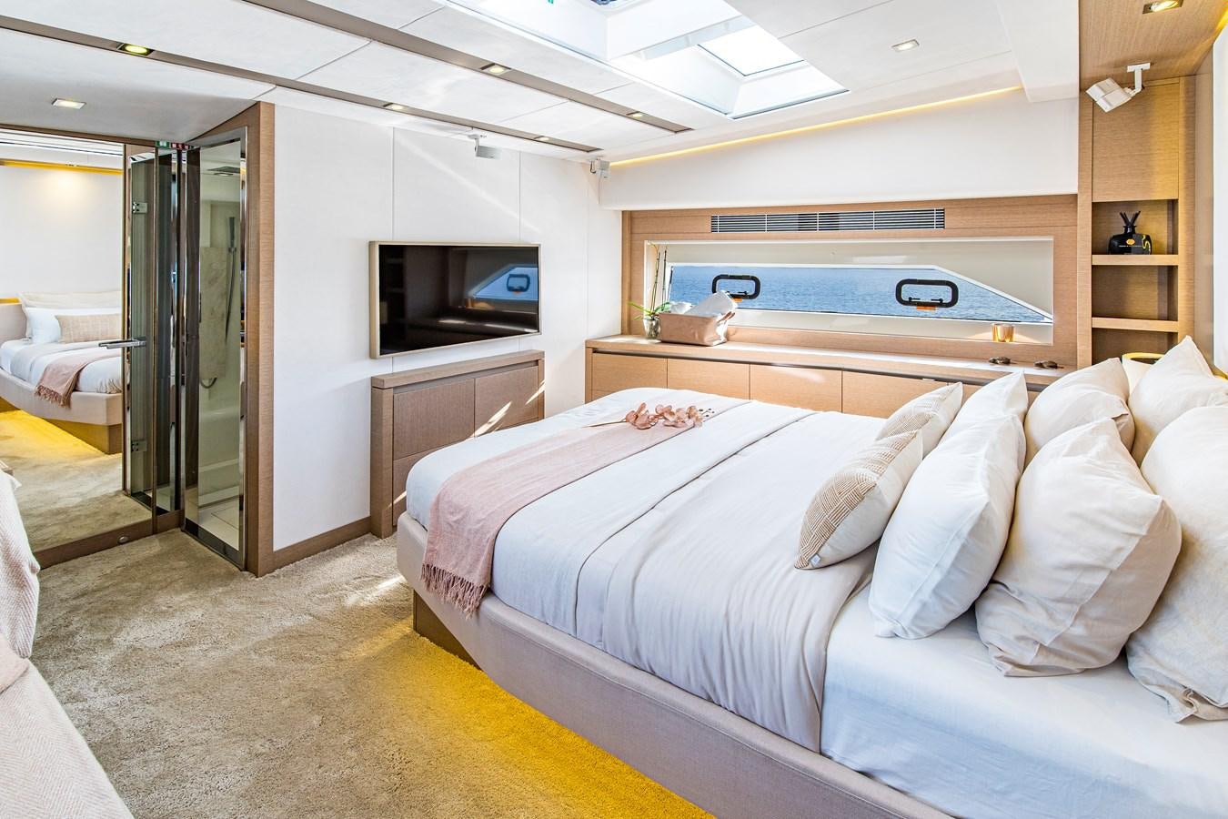 a room with a bed and a television aboard BLUE M Yacht for Sale