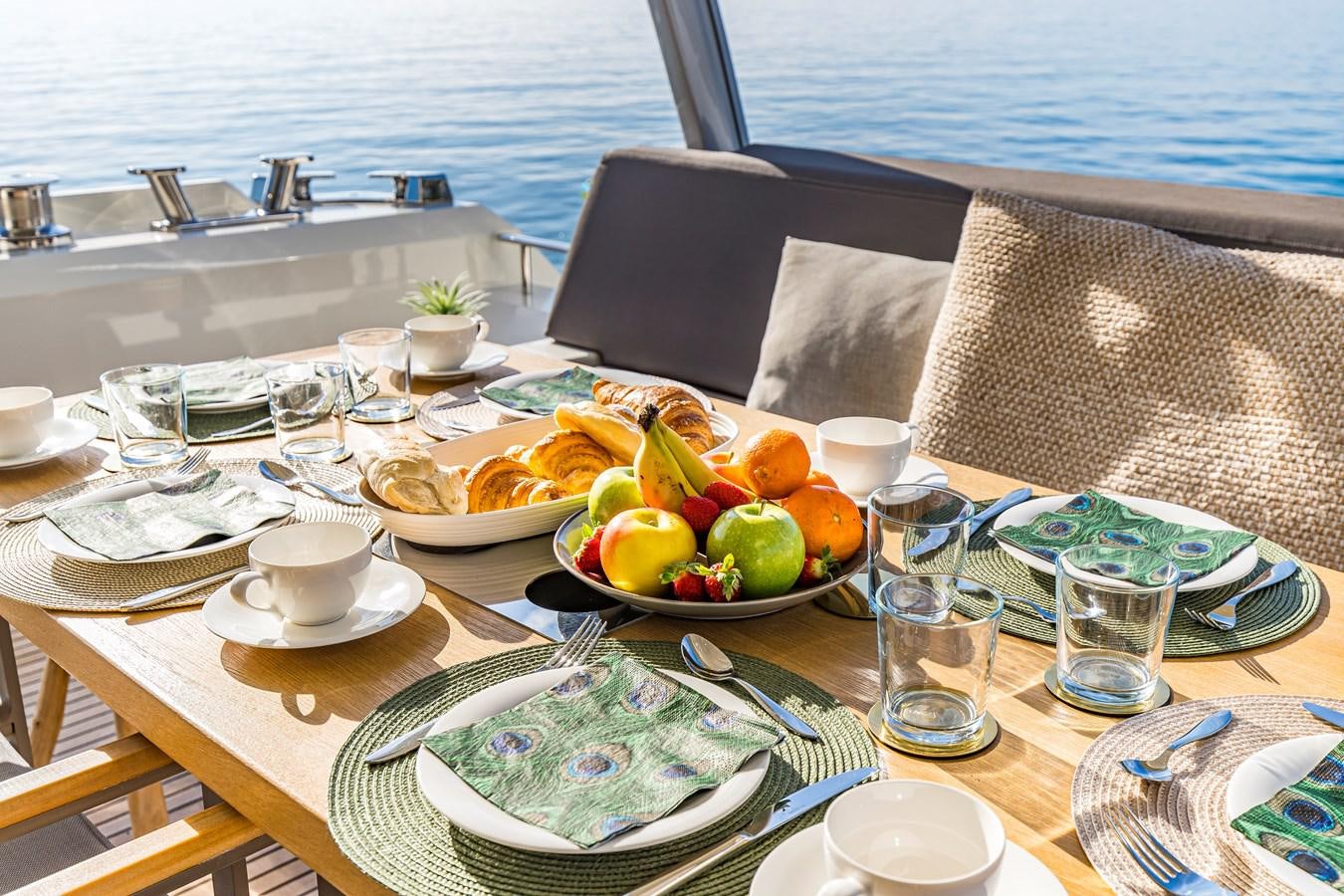 a table with food and drinks on it aboard BLUE M Yacht for Sale