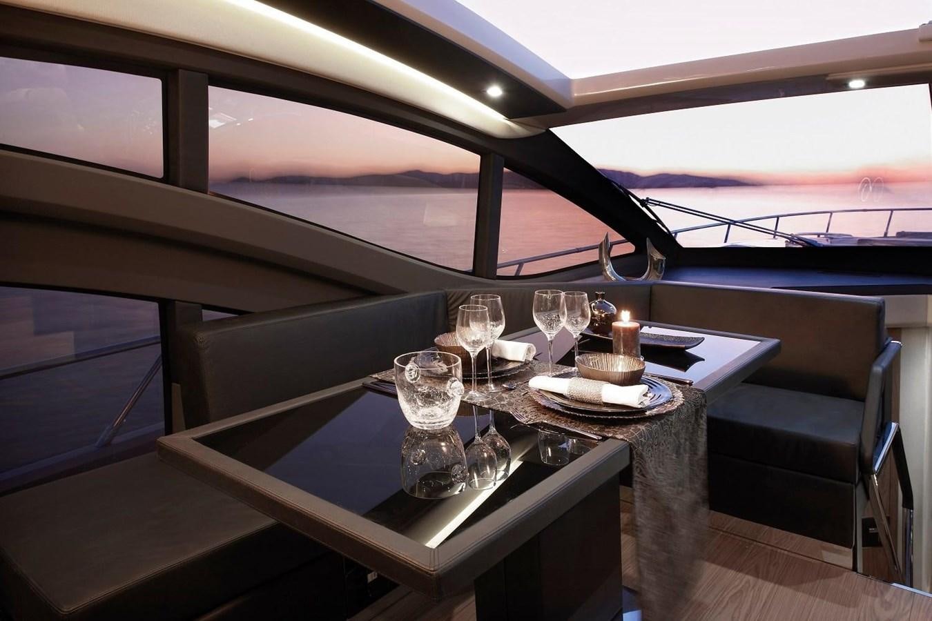 a table with wine glasses on it aboard SESSA MARINE C68 Yacht for Sale