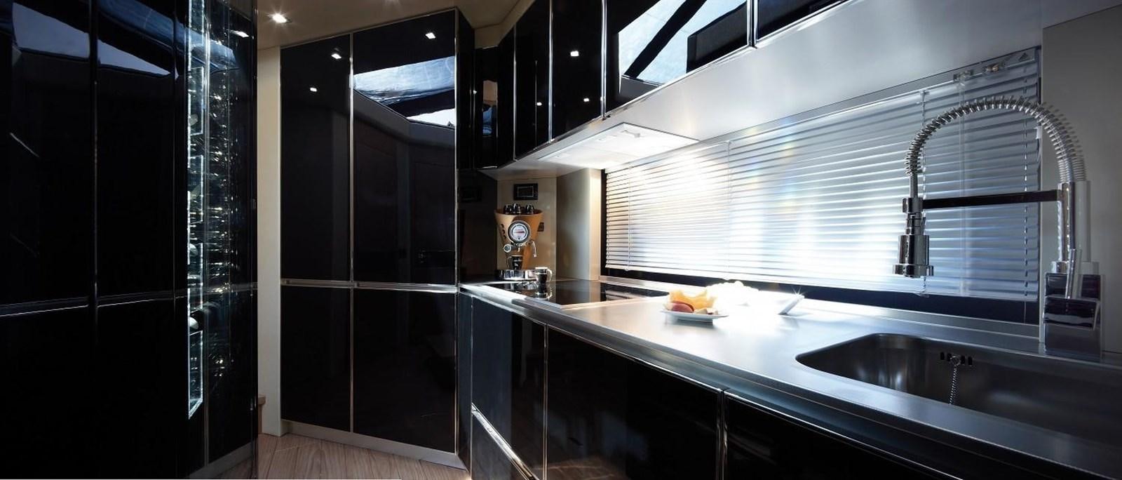 a kitchen with black cabinets aboard SESSA MARINE C68 Yacht for Sale
