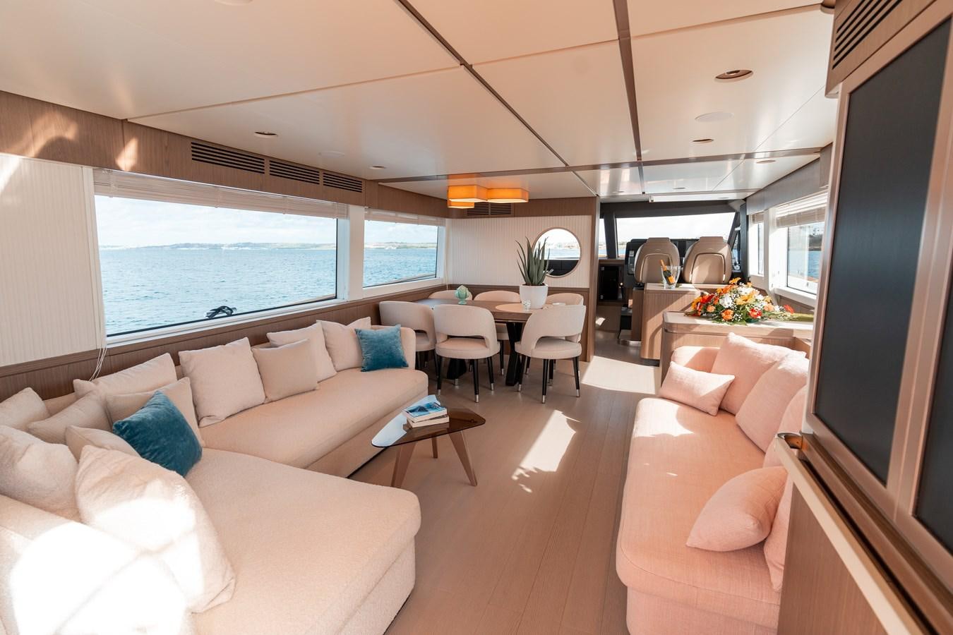 a living room with a large window aboard INIZIA Yacht for Sale