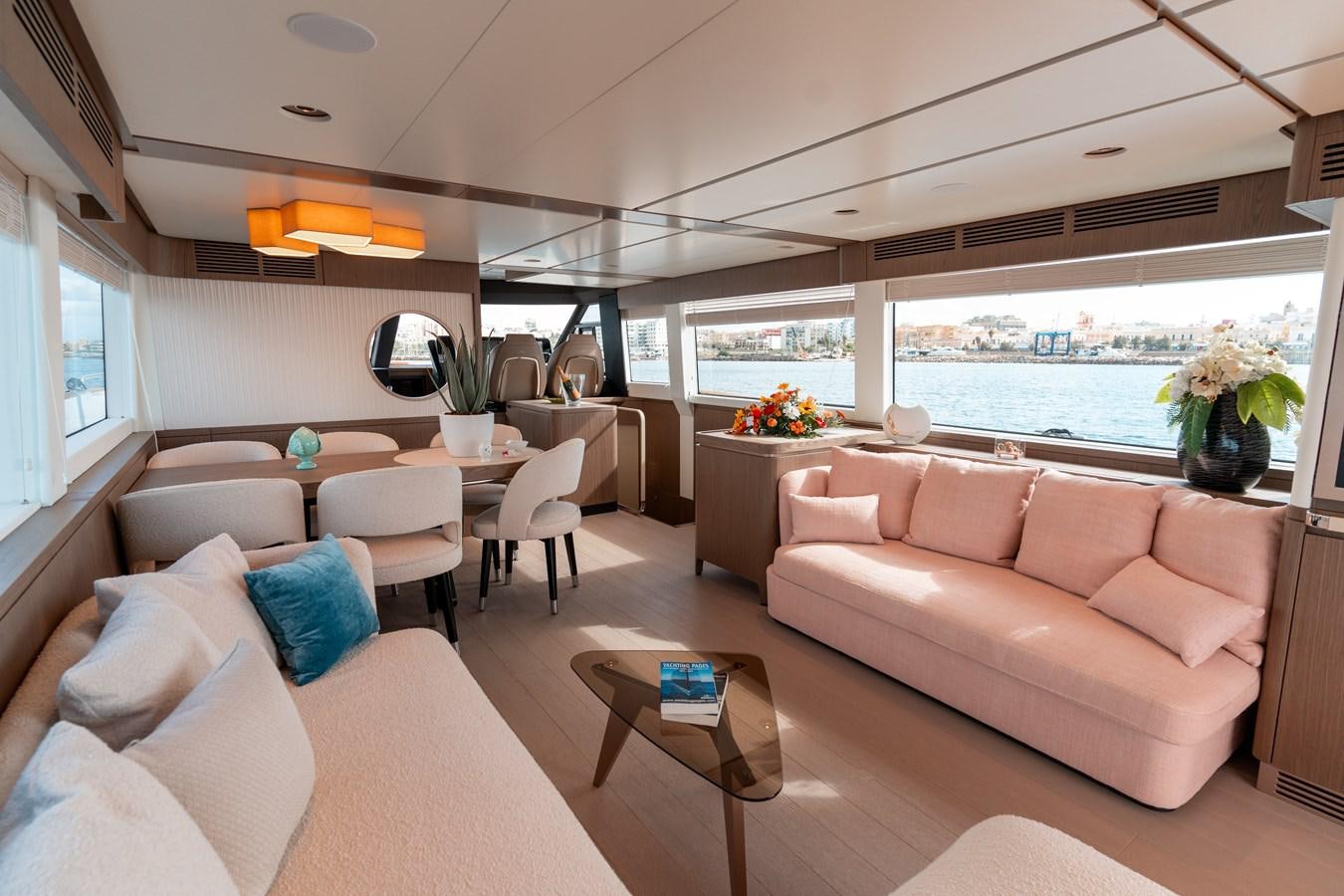 a living room with a large window aboard INIZIA Yacht for Sale
