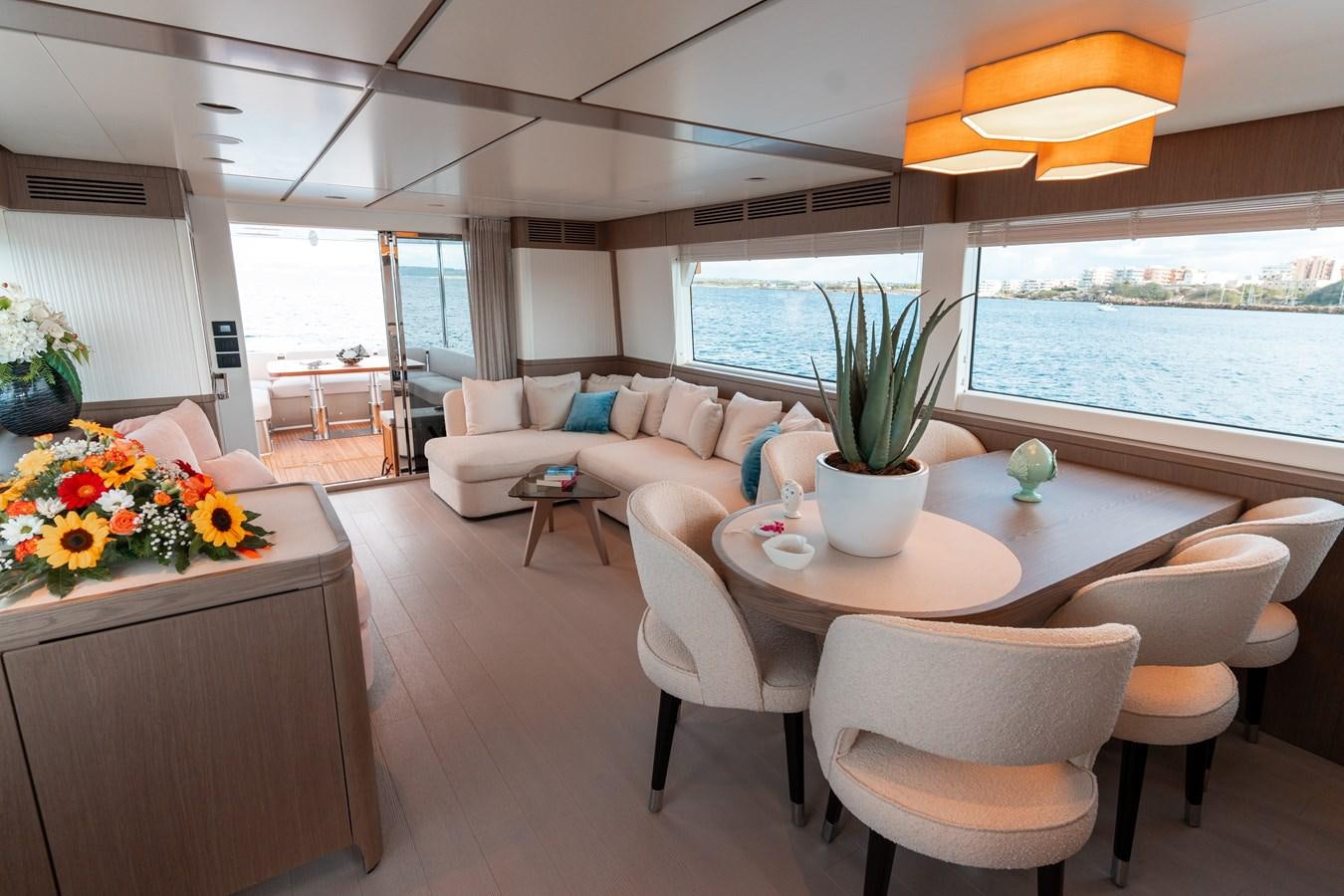 a living room with a table and chairs aboard INIZIA Yacht for Sale