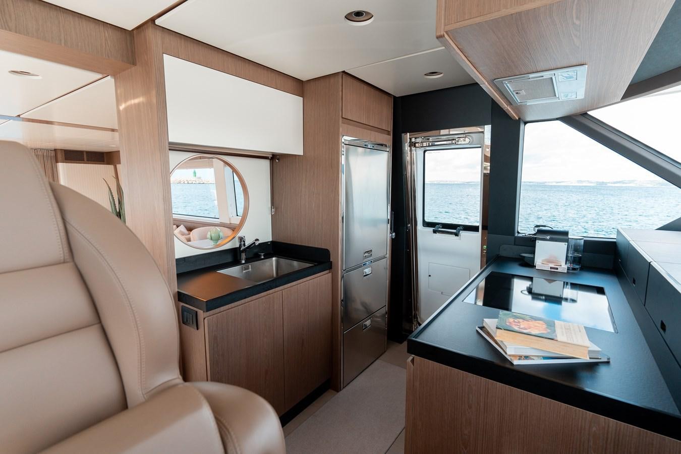 a room with a table and a couch aboard INIZIA Yacht for Sale