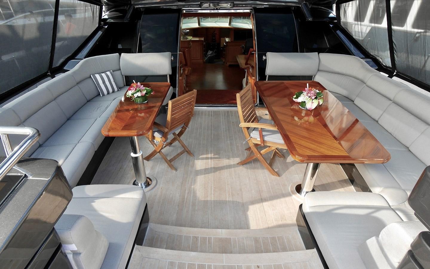 a room with a table chairs and a couch aboard KOKOTEA Yacht for Sale