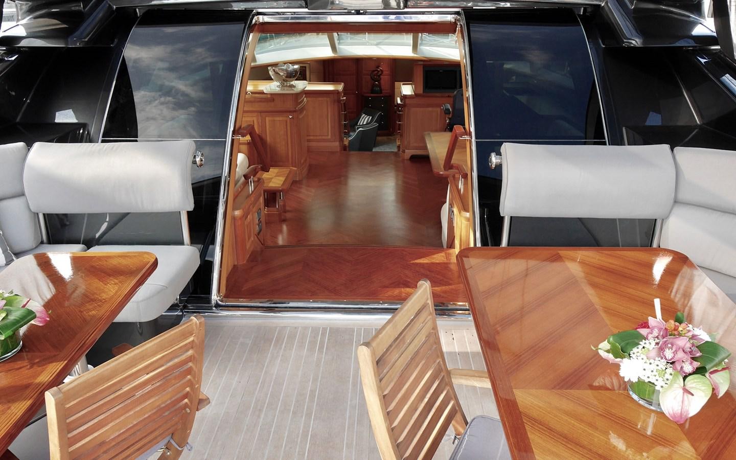 a room with tables and chairs aboard KOKOTEA Yacht for Sale