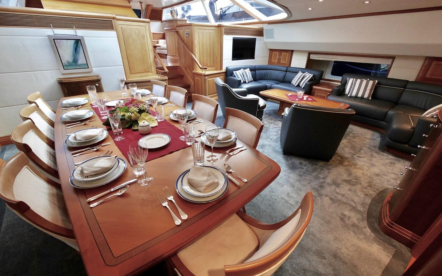 a dining room with a table set aboard KOKOTEA Yacht for Sale