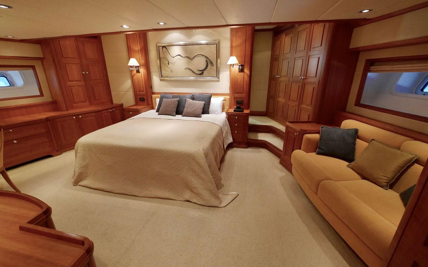 a hotel room with a bed and couches aboard KOKOTEA Yacht for Sale