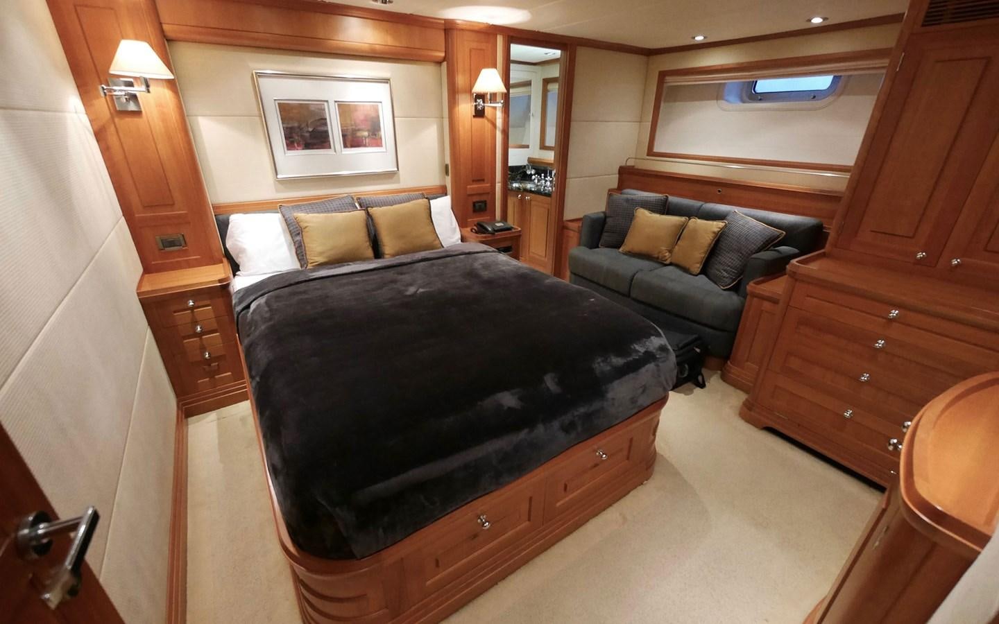 a room with a bed and a couch aboard KOKOTEA Yacht for Sale