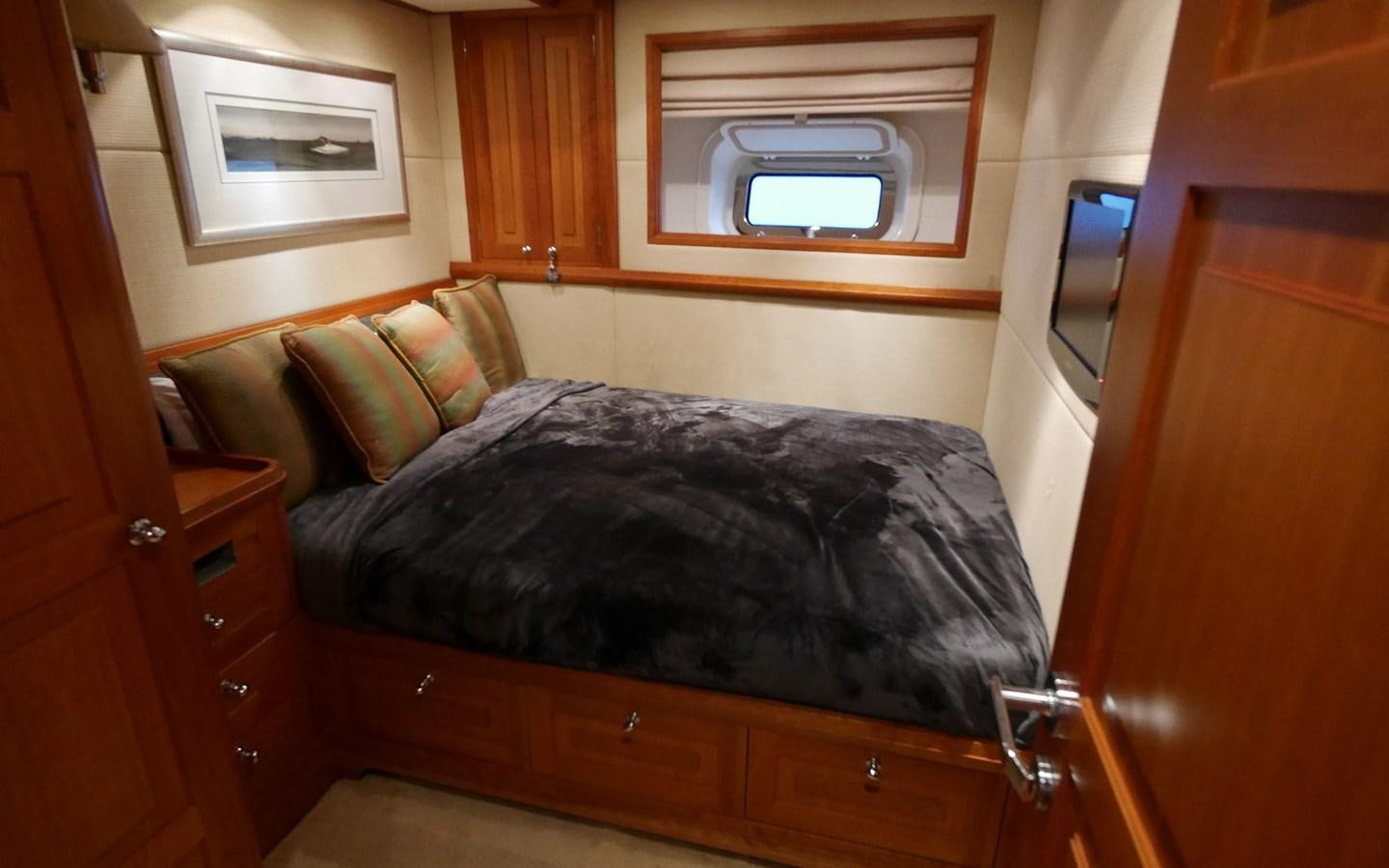 a bed with a black comforter aboard KOKOTEA Yacht for Sale