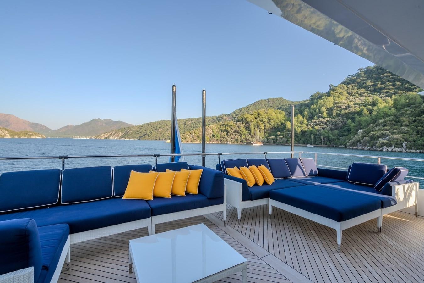 a pool with a deck and chairs aboard CHARISMA Yacht for Sale