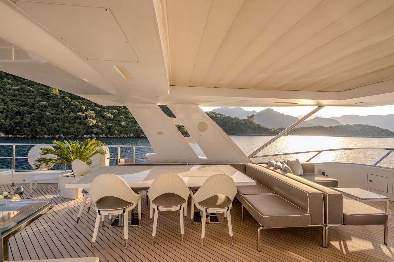 a room with a table chairs and a pool aboard CHARISMA Yacht for Sale