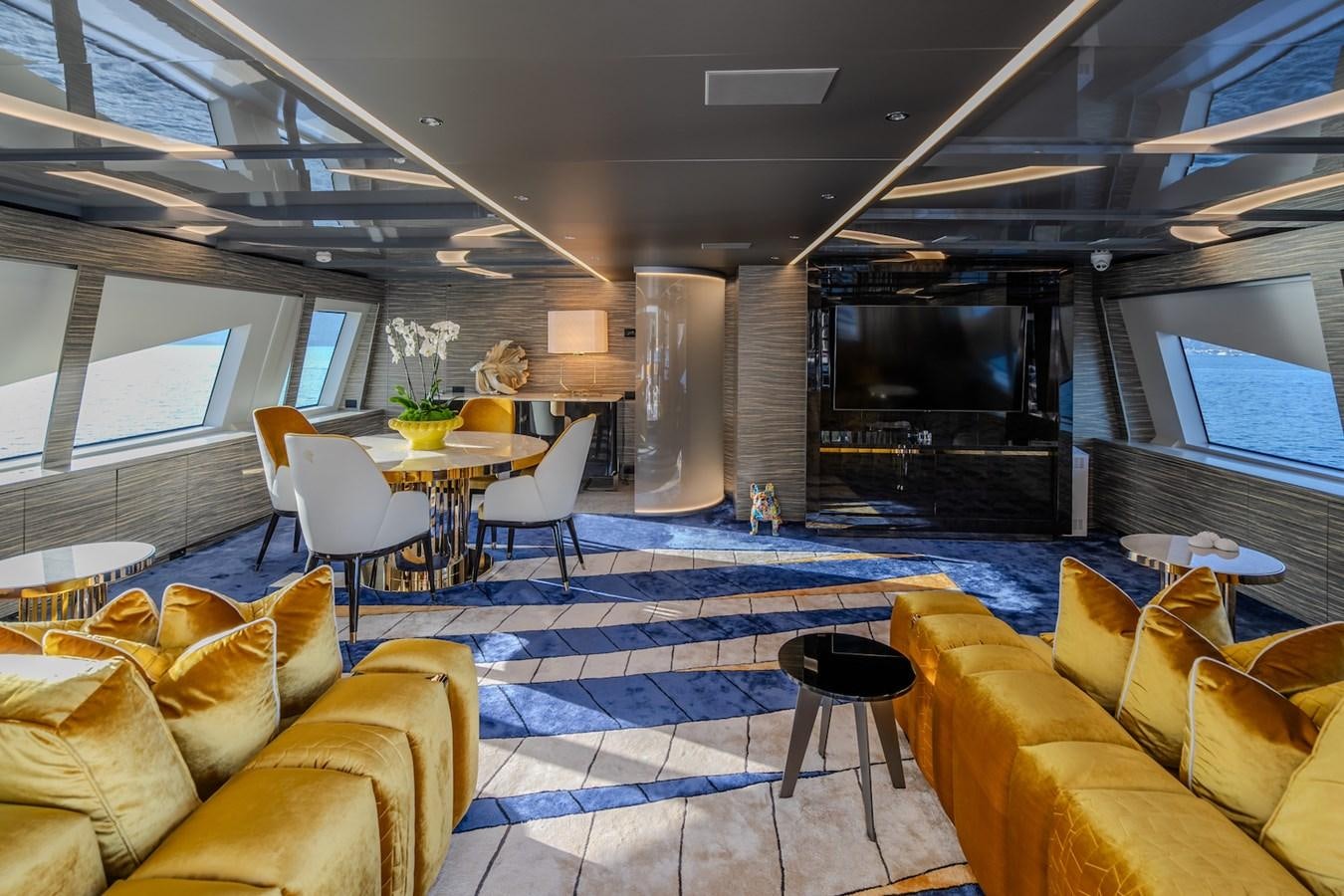 a room with a table and chairs aboard CHARISMA Yacht for Sale