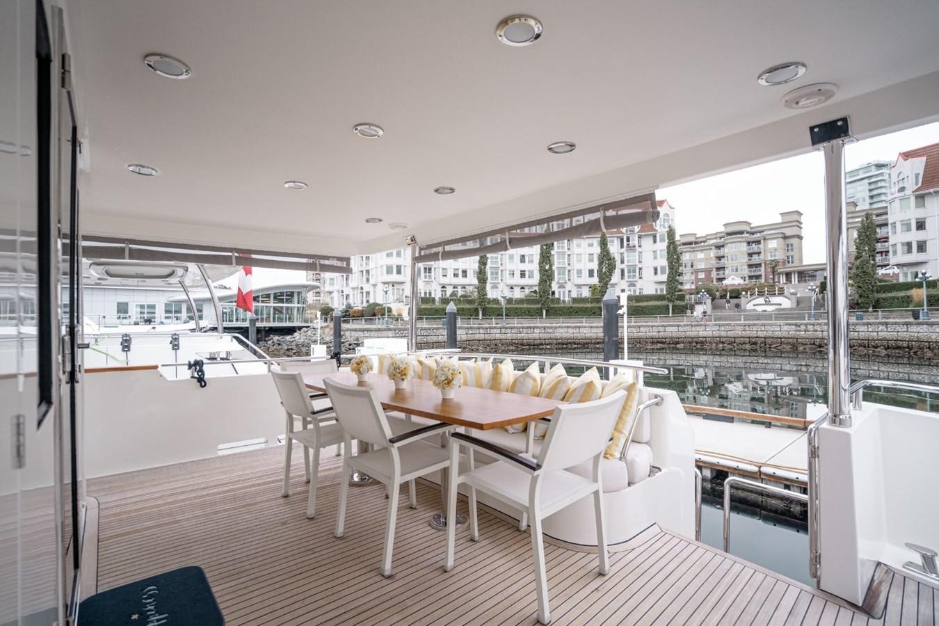a room with a table and chairs aboard HAPPINESS II Yacht for Sale