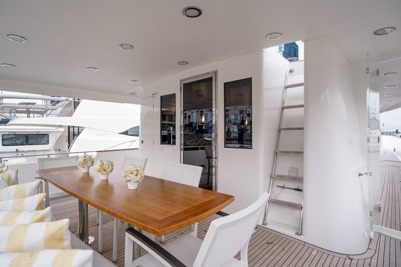 a dining table in a room aboard HAPPINESS II Yacht for Sale