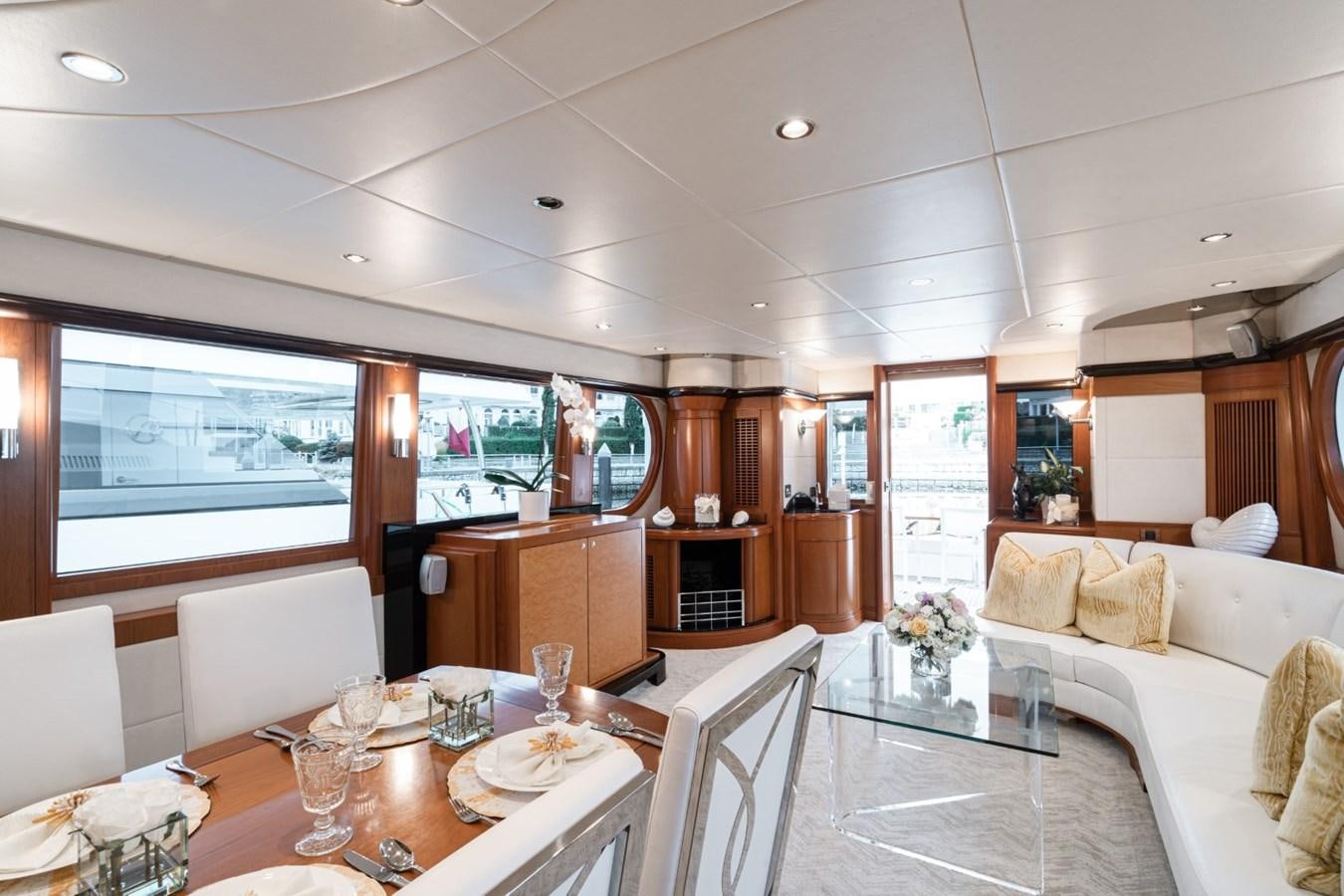 a living room with a table and chairs aboard HAPPINESS II Yacht for Sale