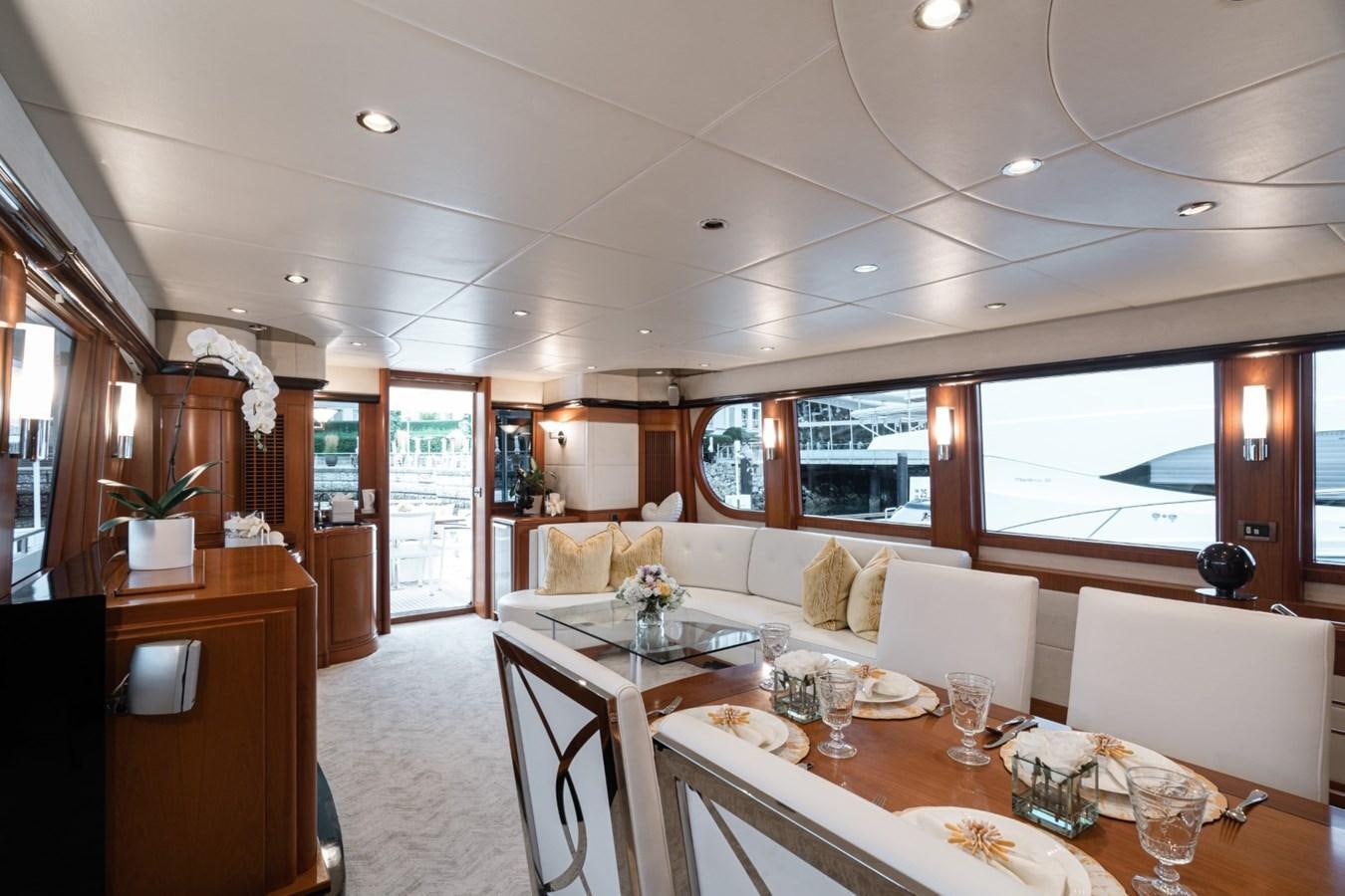 a large white dining room with a large window aboard HAPPINESS II Yacht for Sale