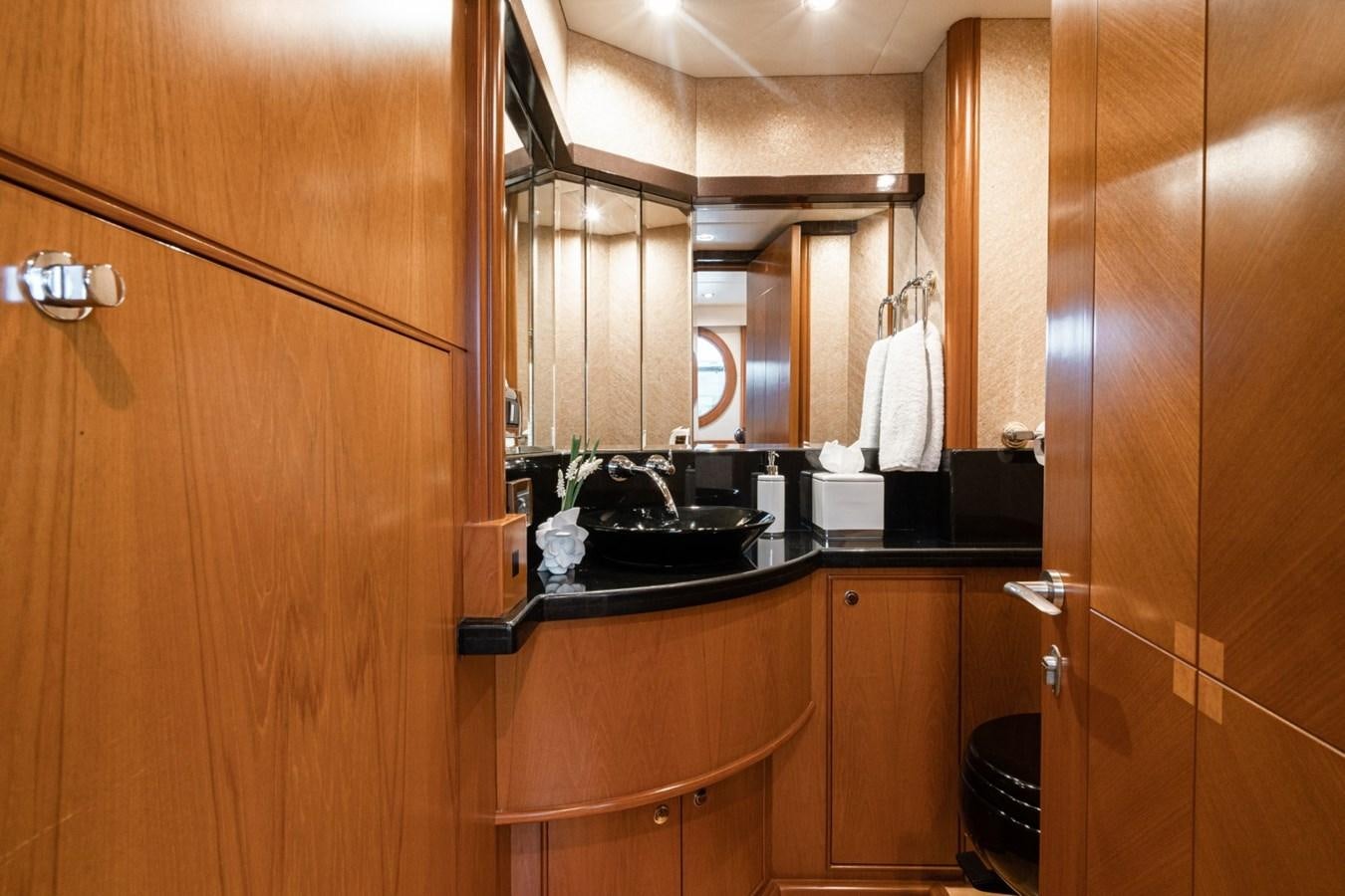 a bathroom with wooden cabinets aboard HAPPINESS II Yacht for Sale