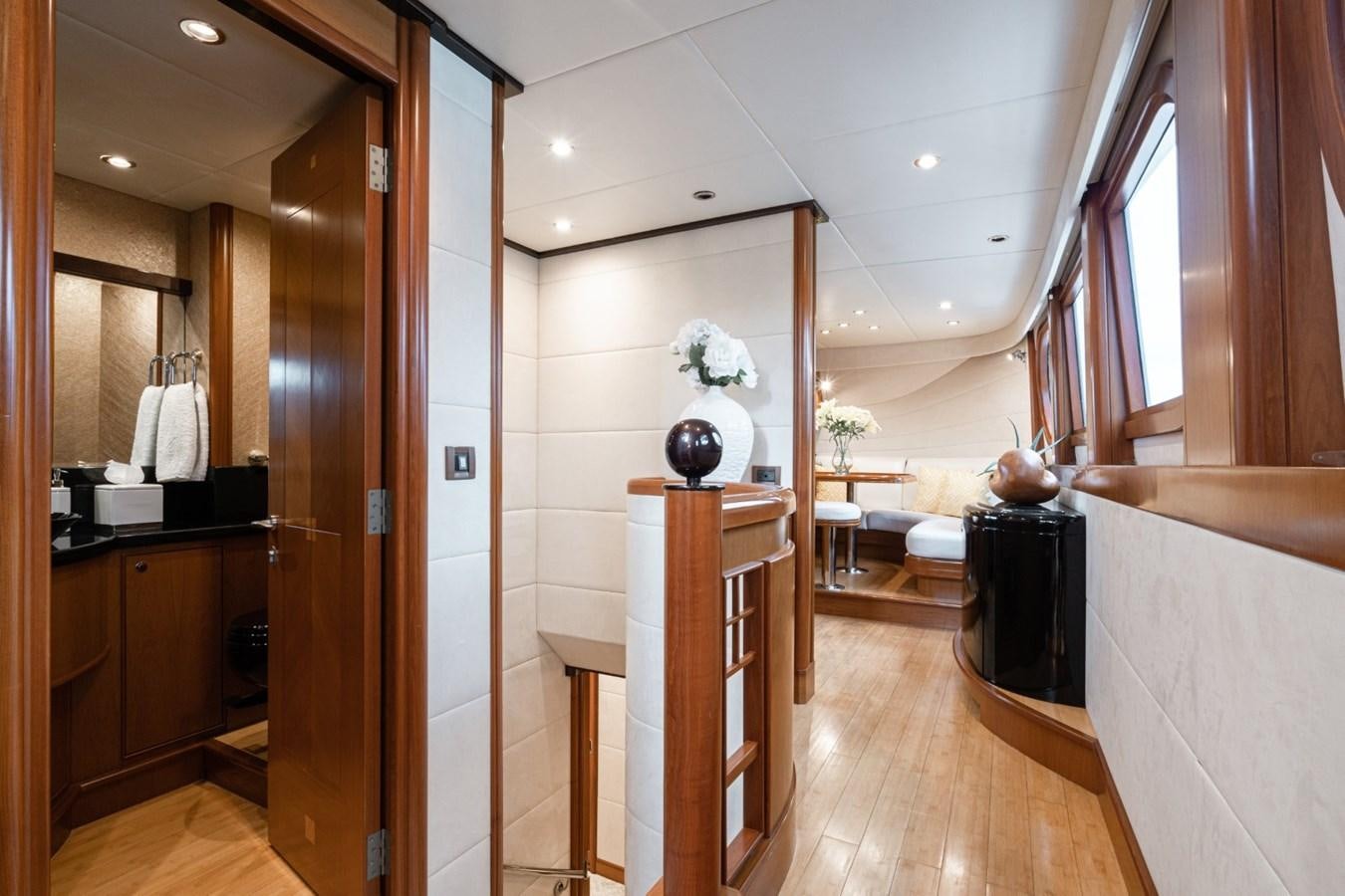 a room with a wood floor and a wood cabinet and a white wall aboard HAPPINESS II Yacht for Sale