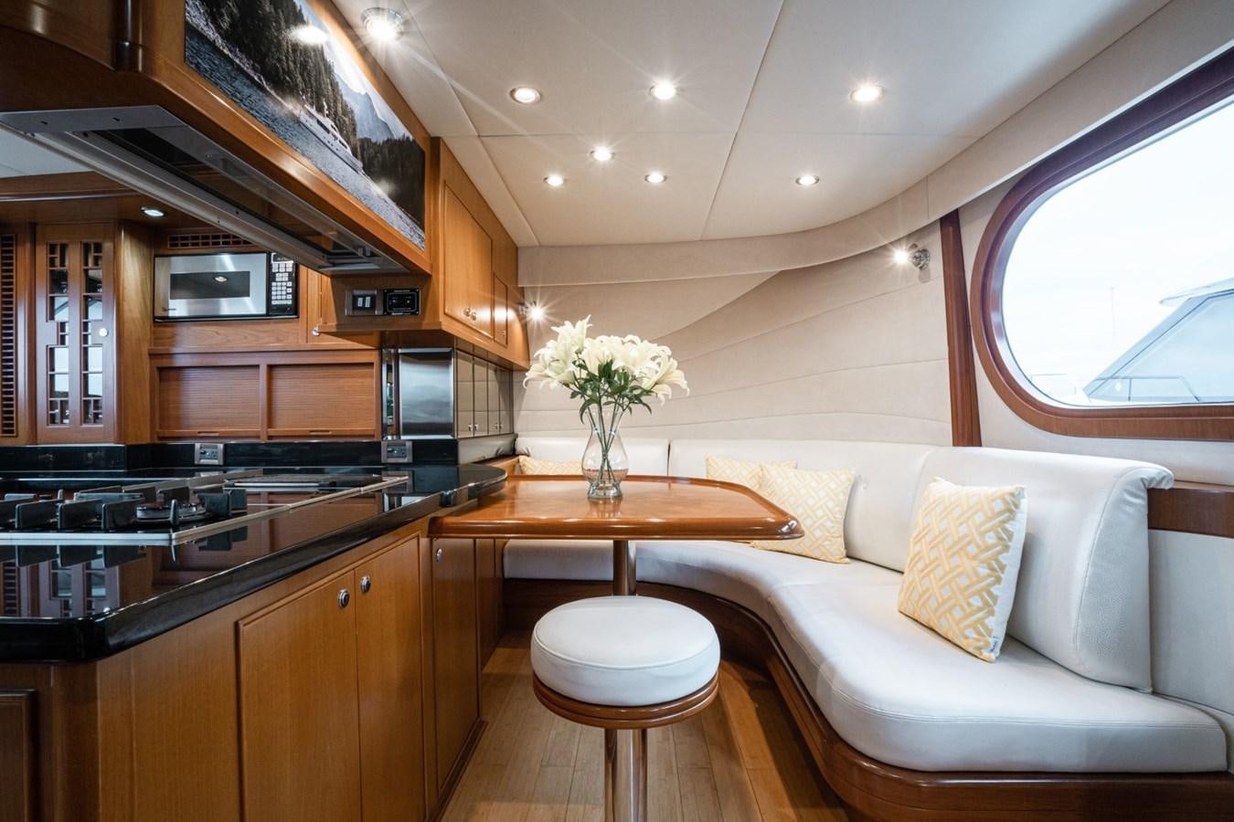 a living room with a couch and a table aboard HAPPINESS II Yacht for Sale