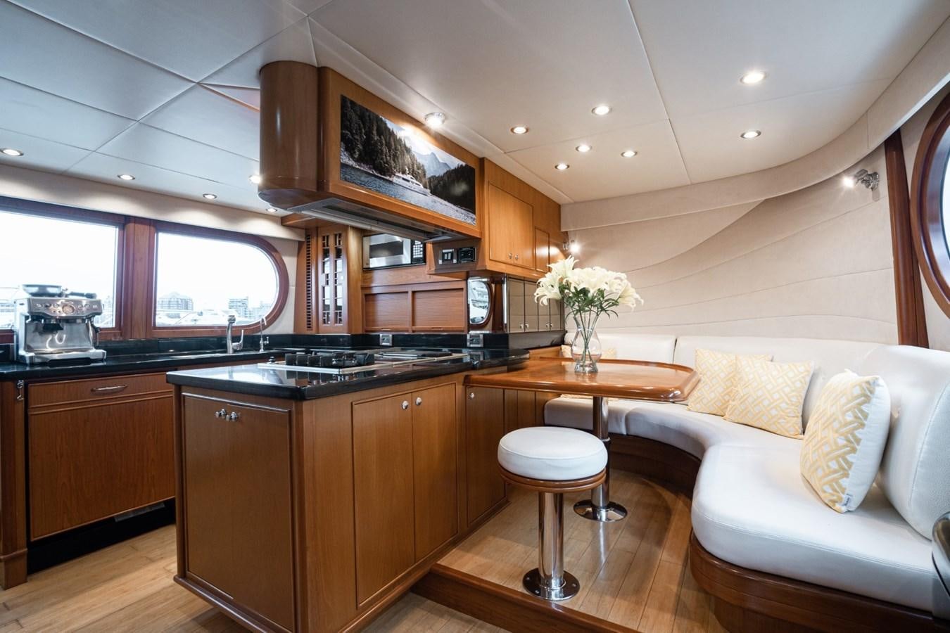 a kitchen with a table and a couch aboard HAPPINESS II Yacht for Sale