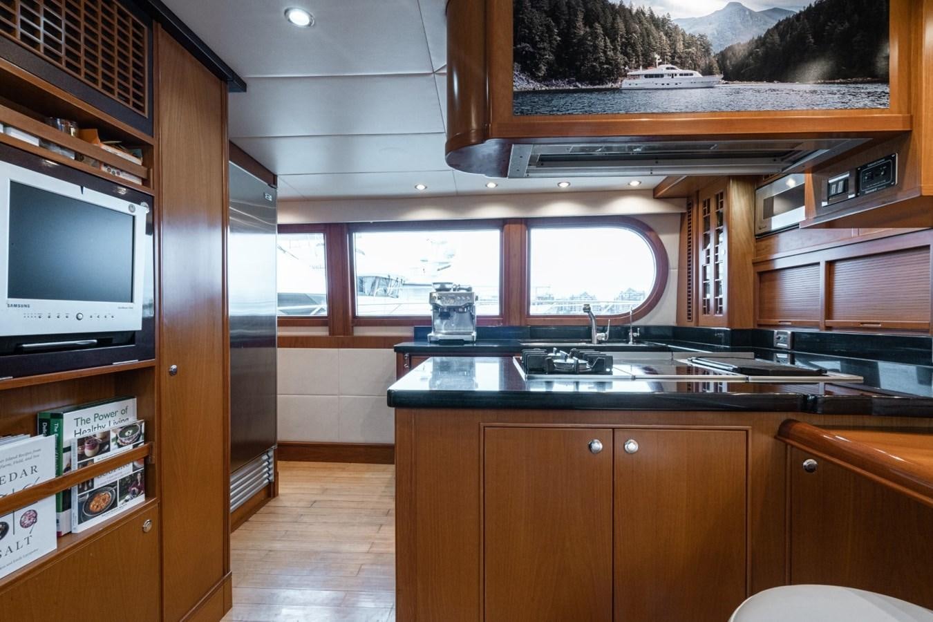 a kitchen with wooden cabinets aboard HAPPINESS II Yacht for Sale