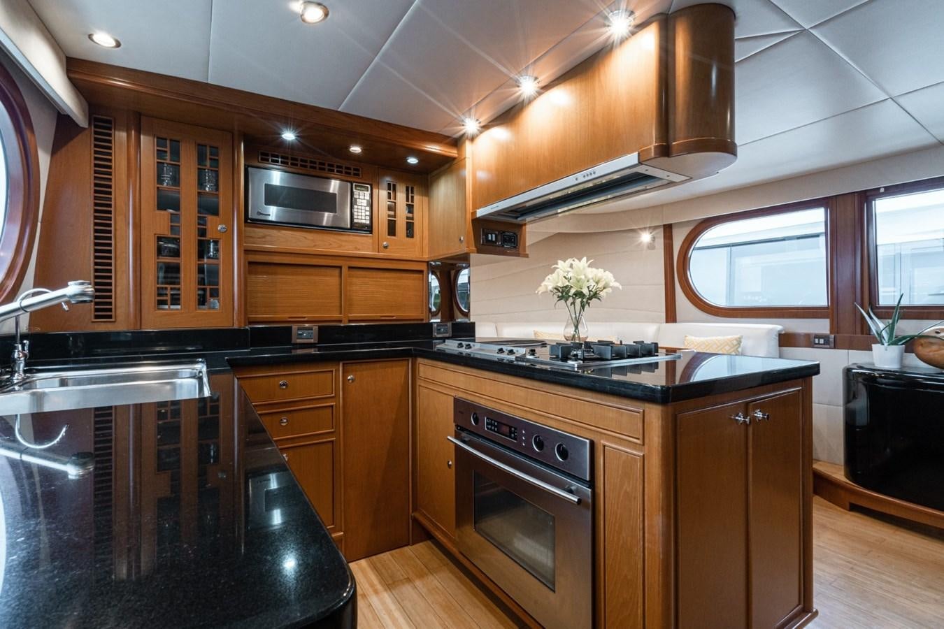 a kitchen with wooden cabinets aboard HAPPINESS II Yacht for Sale