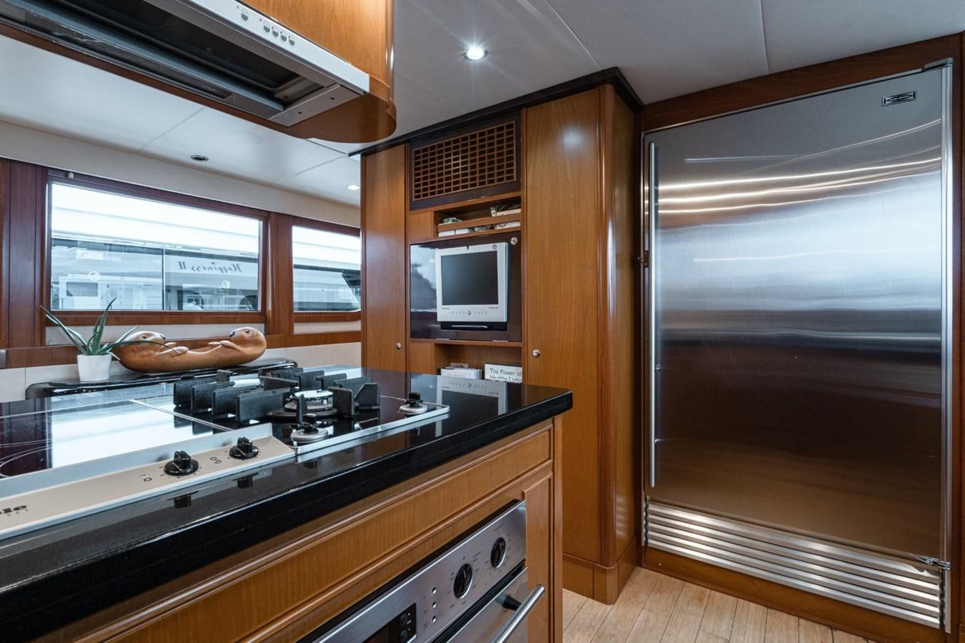 a kitchen with a sliding glass door aboard HAPPINESS II Yacht for Sale
