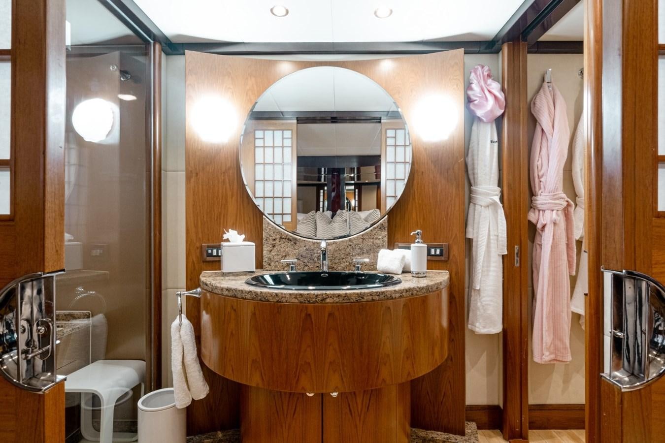 a bathroom with a large mirror aboard HAPPINESS II Yacht for Sale