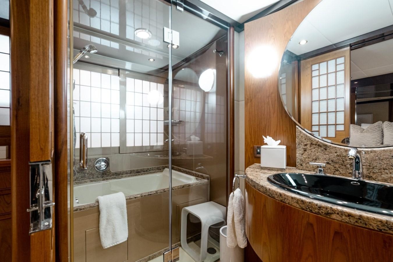 a bathroom with a glass shower aboard HAPPINESS II Yacht for Sale