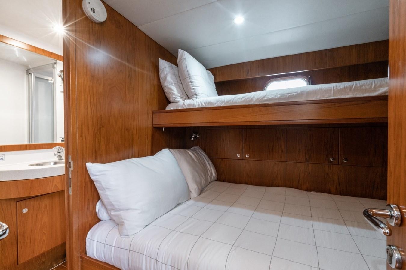 a bed with white sheets aboard HAPPINESS II Yacht for Sale