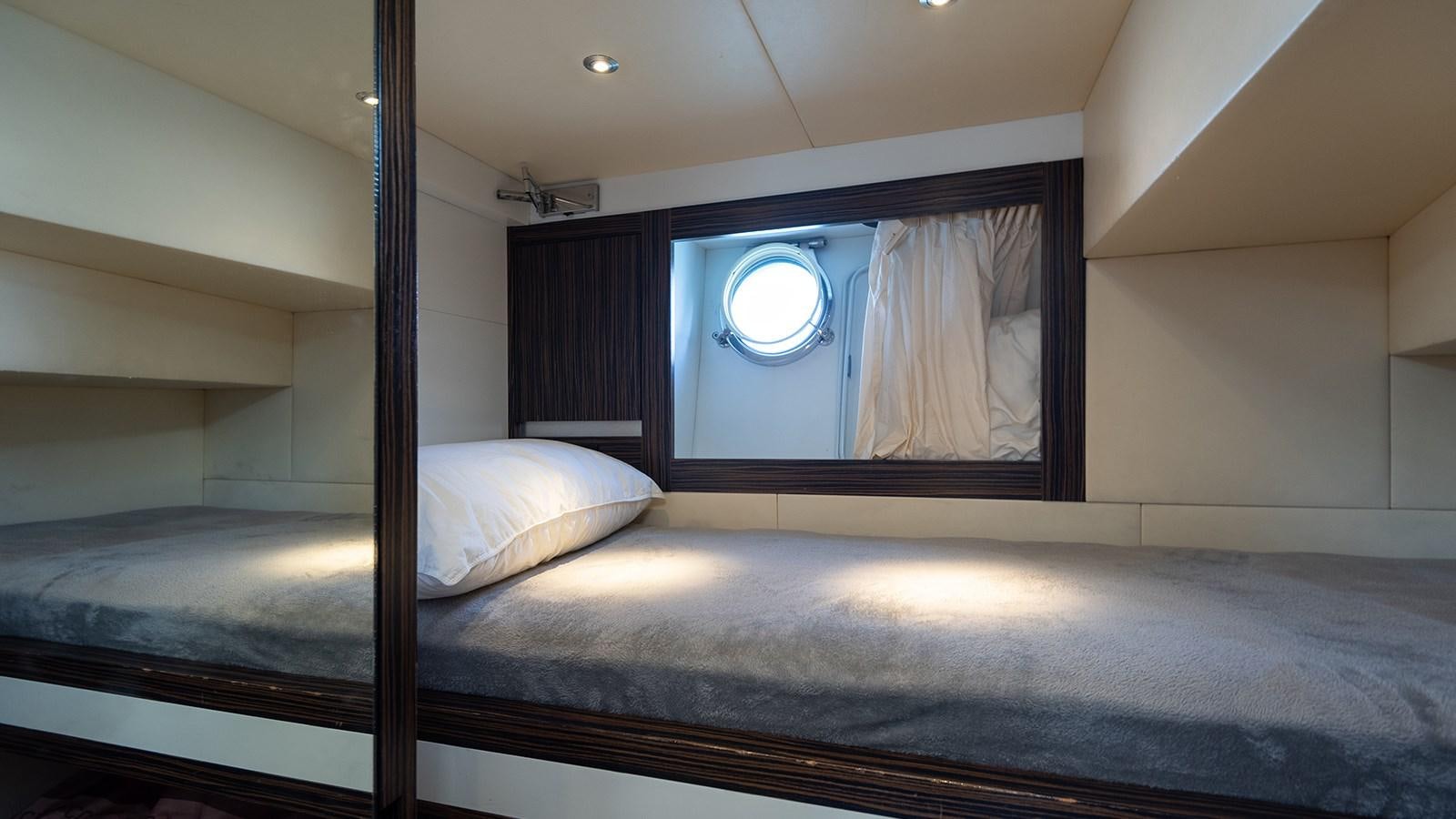a bed with a mirror above it aboard FRADI Yacht for Sale