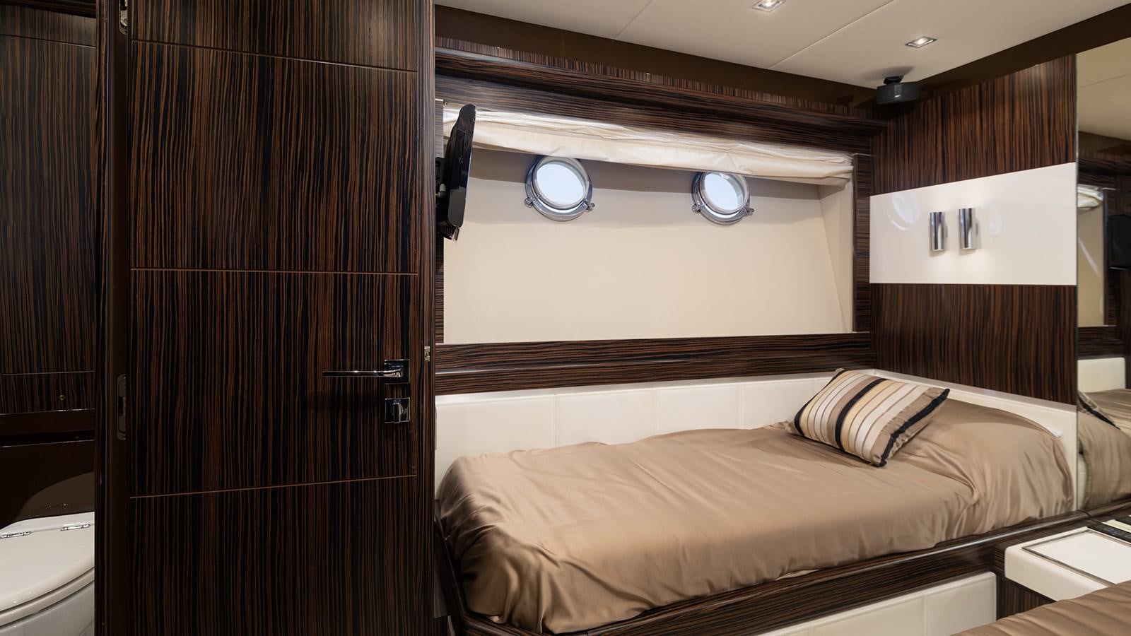 a room with a bed and a mirror aboard FRADI Yacht for Sale