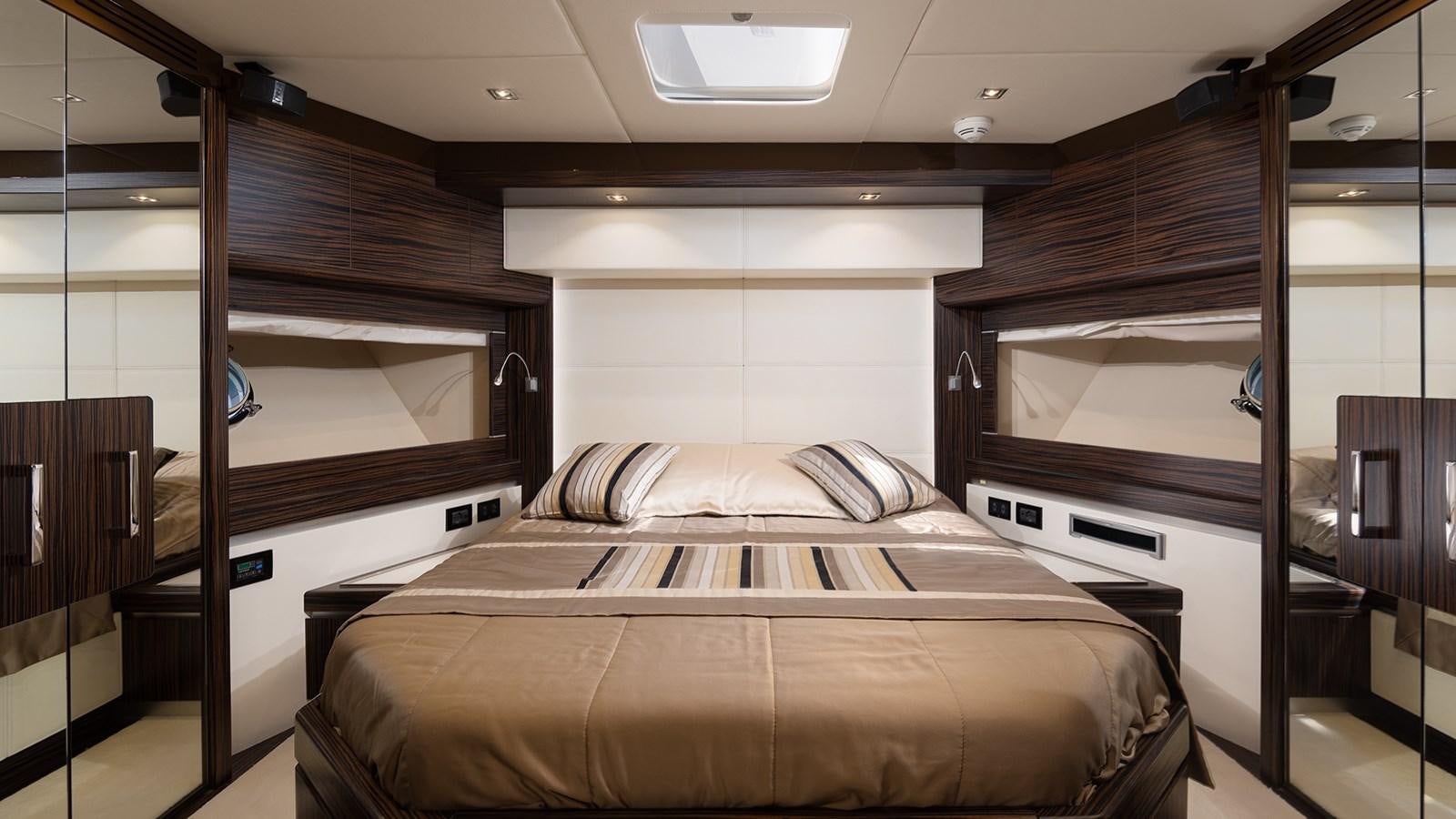 a bedroom with a bed and a mirror aboard FRADI Yacht for Sale