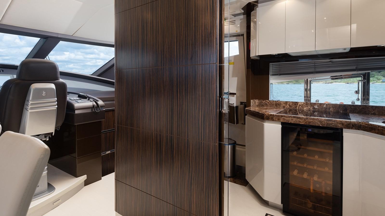 a room with a wood door and cabinets aboard FRADI Yacht for Sale