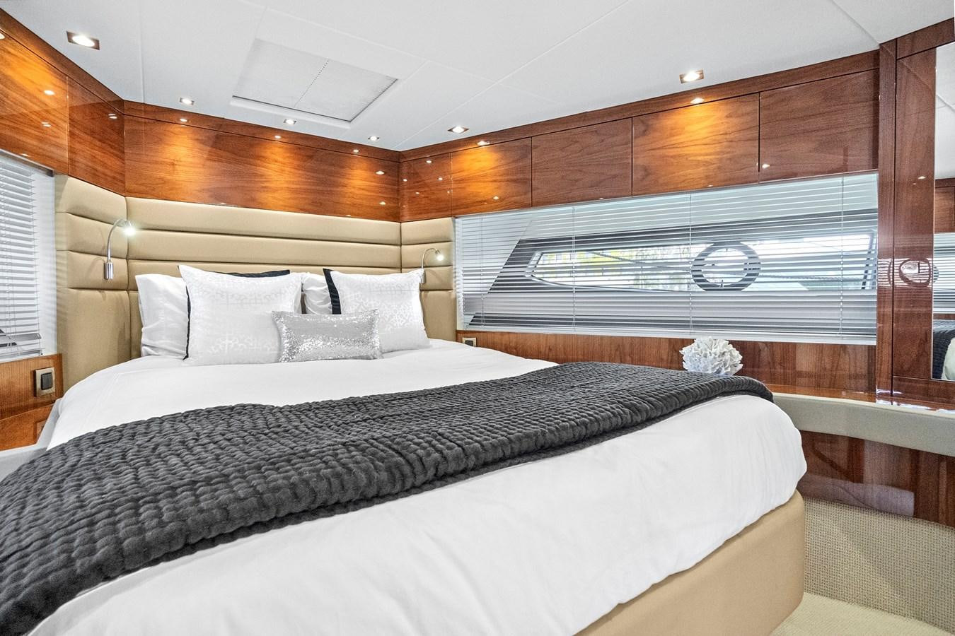 a bed with a black and white bed spread aboard EXIT Yacht for Sale