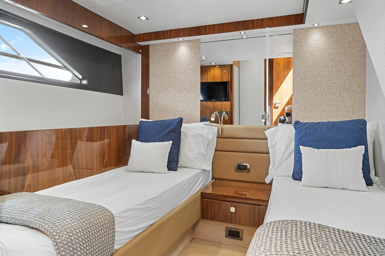a room with a bed and a television aboard EXIT Yacht for Sale