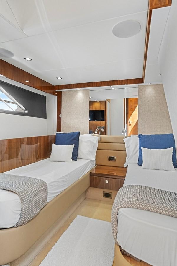 a room with a bed and a dresser aboard EXIT Yacht for Sale
