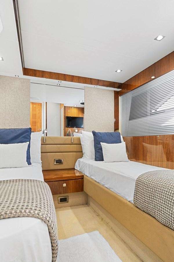 a room with a bed and a dresser aboard EXIT Yacht for Sale