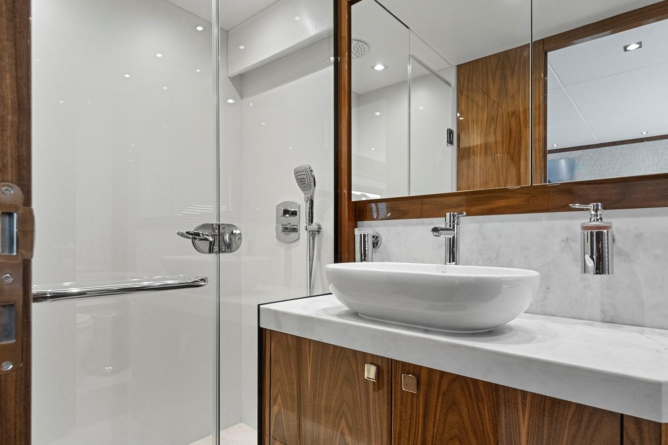 a bathroom with a sink and a mirror aboard EXIT Yacht for Sale