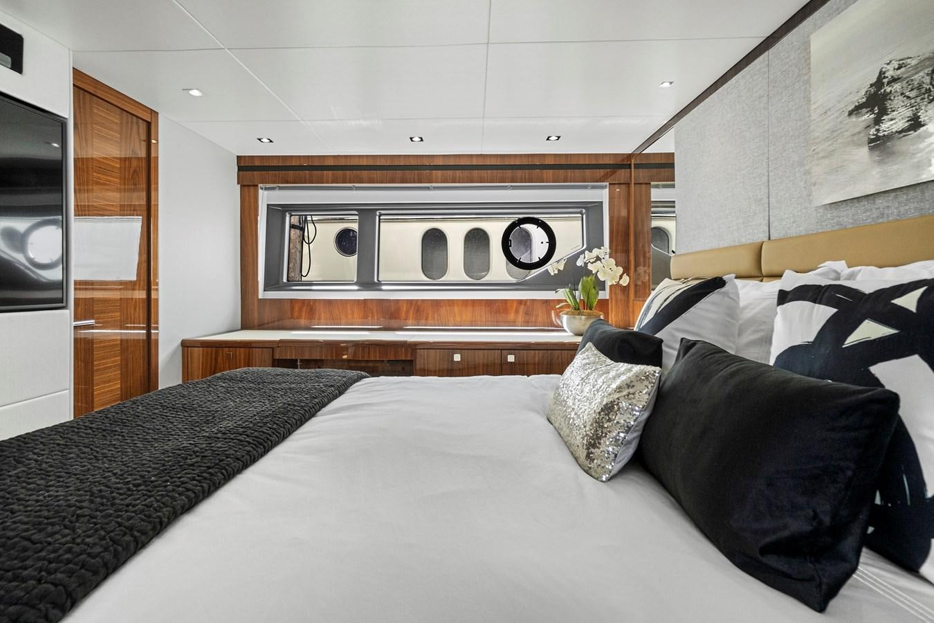 a bed with pillows and a fireplace aboard EXIT Yacht for Sale